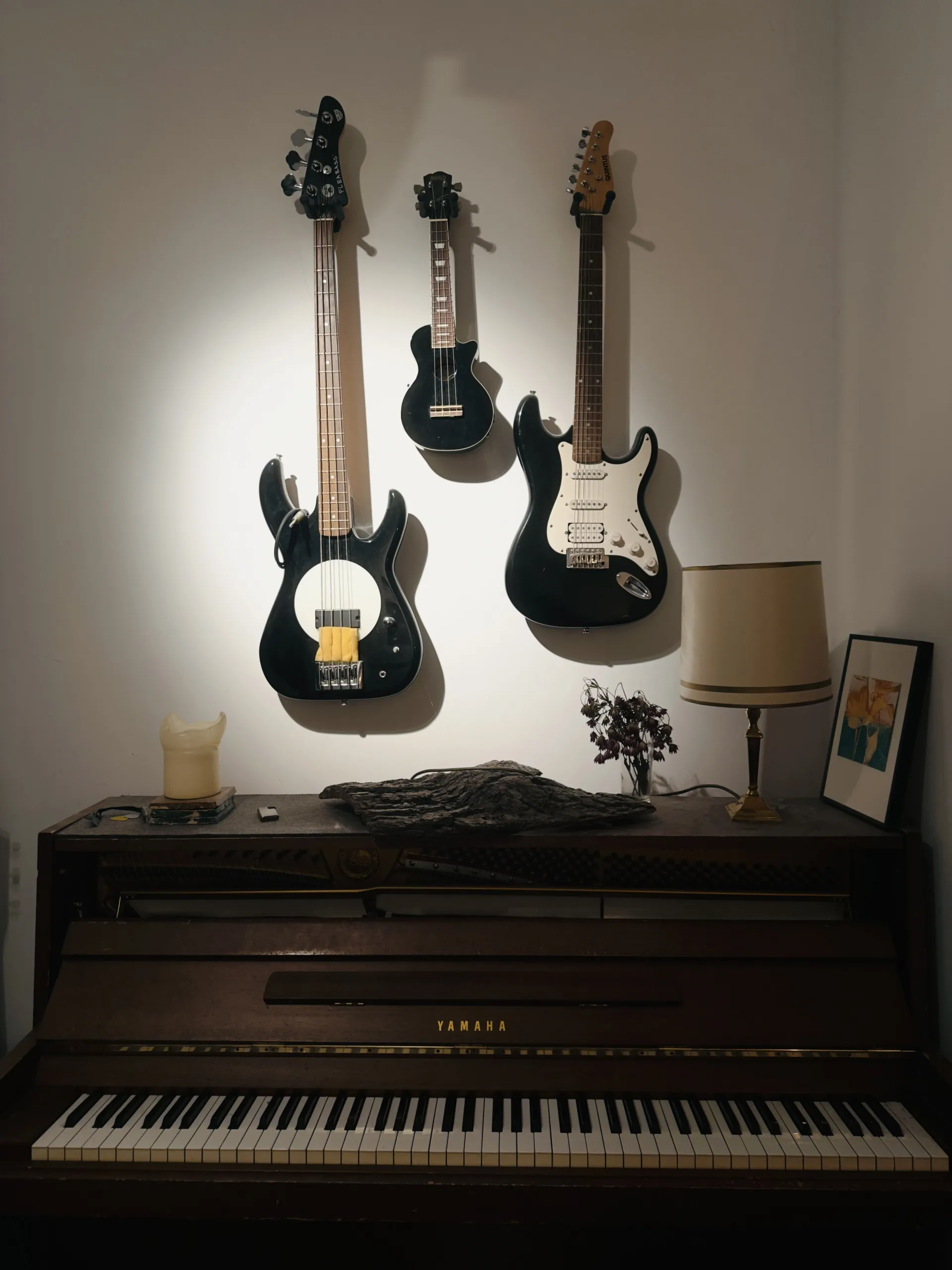 Emil Vorbrugg - Collection of instruments including bass, guitar, and Yamaha piano